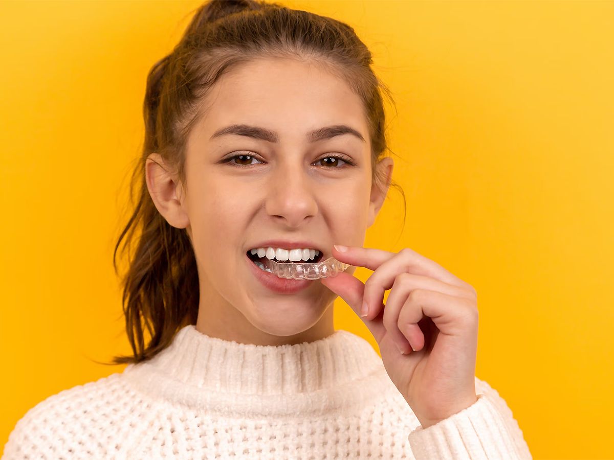 Woman smiling in yellow t-shirt